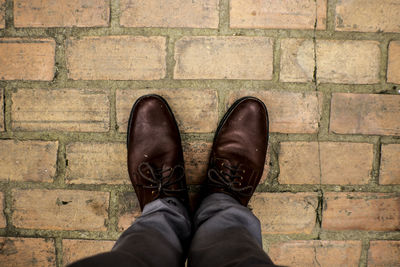 Low section of man standing on footpath