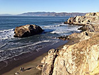 Scenic view of sea with mountain range in background