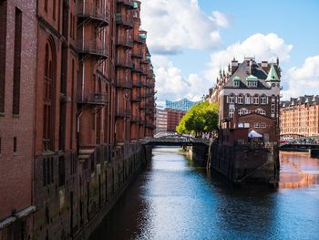 Bridge over river amidst buildings in city