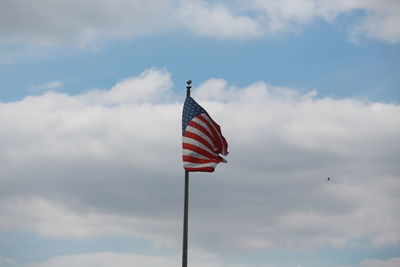 Low angle view of american flag against sky