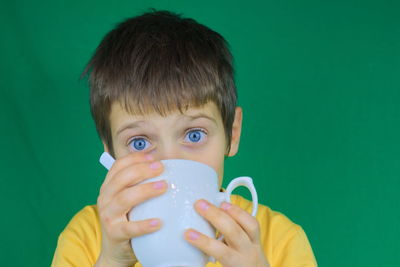 Portrait of boy drinking water