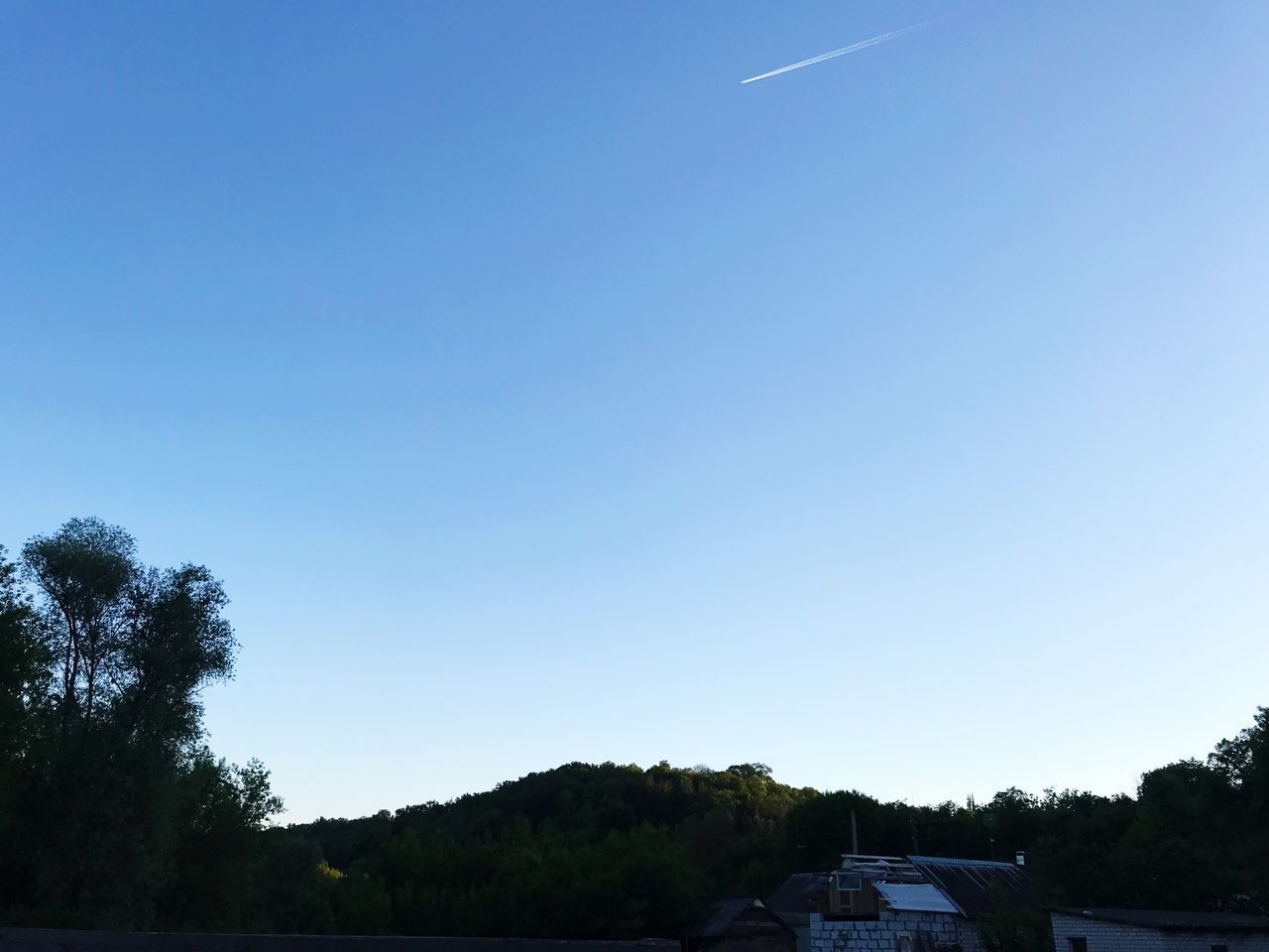 HOUSES AGAINST CLEAR BLUE SKY