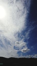 Low angle view of silhouette landscape against sky