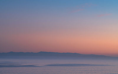 Scenic view of sea against clear sky during sunset