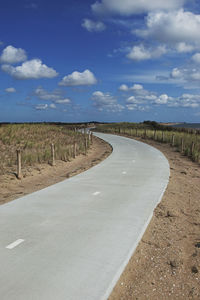 Empty road along countryside landscape