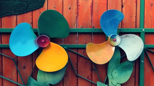 Close-up of colorful electric fans decorated on wall