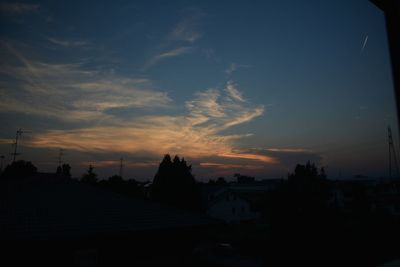 Silhouette of roof against sky during sunset