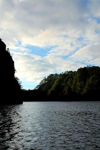 Scenic view of lake by trees against sky