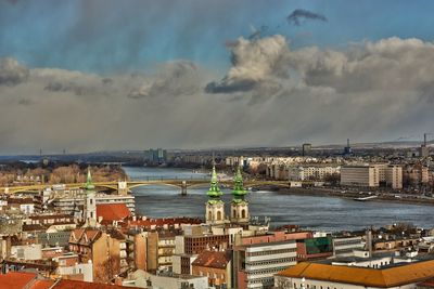 High angle view of buildings against cloudy sky