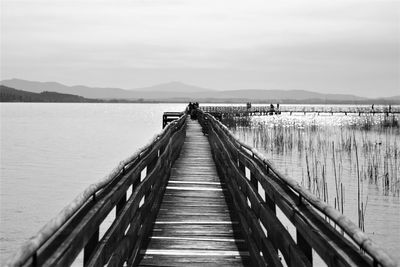 Pier on footbridge against sky