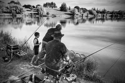 Rear view of man fishing in lake