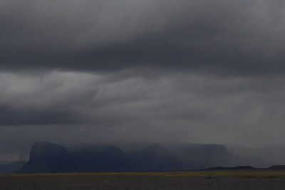 View of storm clouds over landscape
