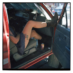 Midsection of woman sitting in car