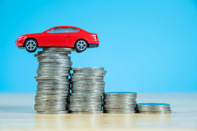 Close-up of coin stack against blue background