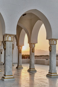 Courtyard of big mosque in sharm el sheikh, egypt during sunset. arches and columns in white marble 