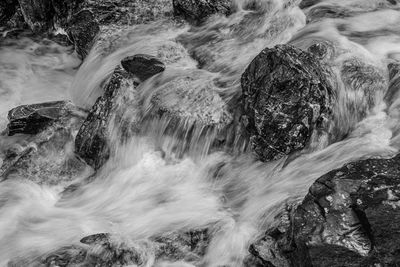 Blurred motion of water over rocks in mountain river