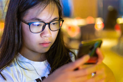 Portrait of teenage girl using mobile phone