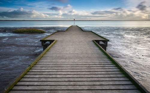 Pier over sea against sky