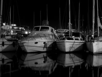 Sailboats in marina at night