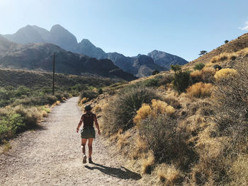 Rear view of man walking on mountain