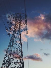 Low angle view of electricity pylon against sky