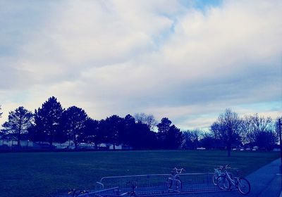 Scenic view of field against cloudy sky