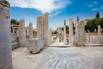 Tourists visiting the ancient ruins at the roman agora in athens