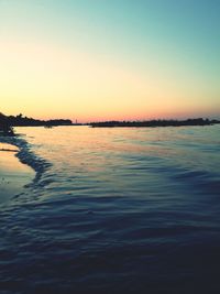 Scenic view of sea against clear sky during sunset