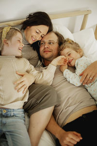 Family lying in bed