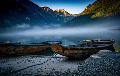 Scenic view of lake by mountains against sky