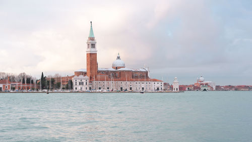 View of cathedral in sea against cloudy sky