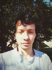 Portrait of young man against plants