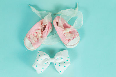 High angle view of shoes and tied bow on table
