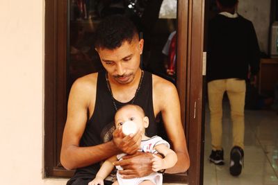 Full length of father holding baby