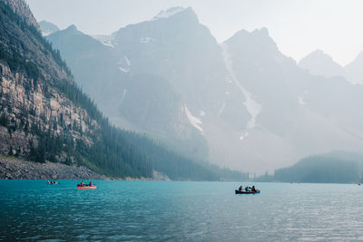 Scenic view of sea and mountains against sky