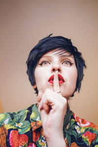 Smiling woman with make-up against colored background