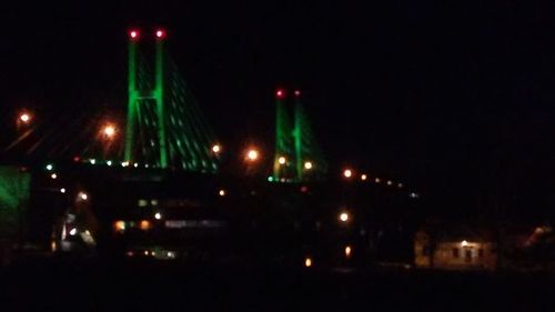 Illuminated building against sky at night