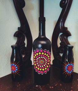 Close-up of multi colored bottles on table