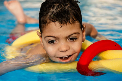 Portrait of cute boy in swimming pool