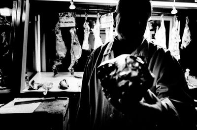 Butcher holding meat at market