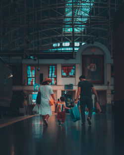 Rear view of people walking in building