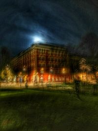 Digital composite image of illuminated buildings against sky at night