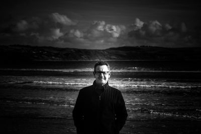 Portrait of young man standing on beach