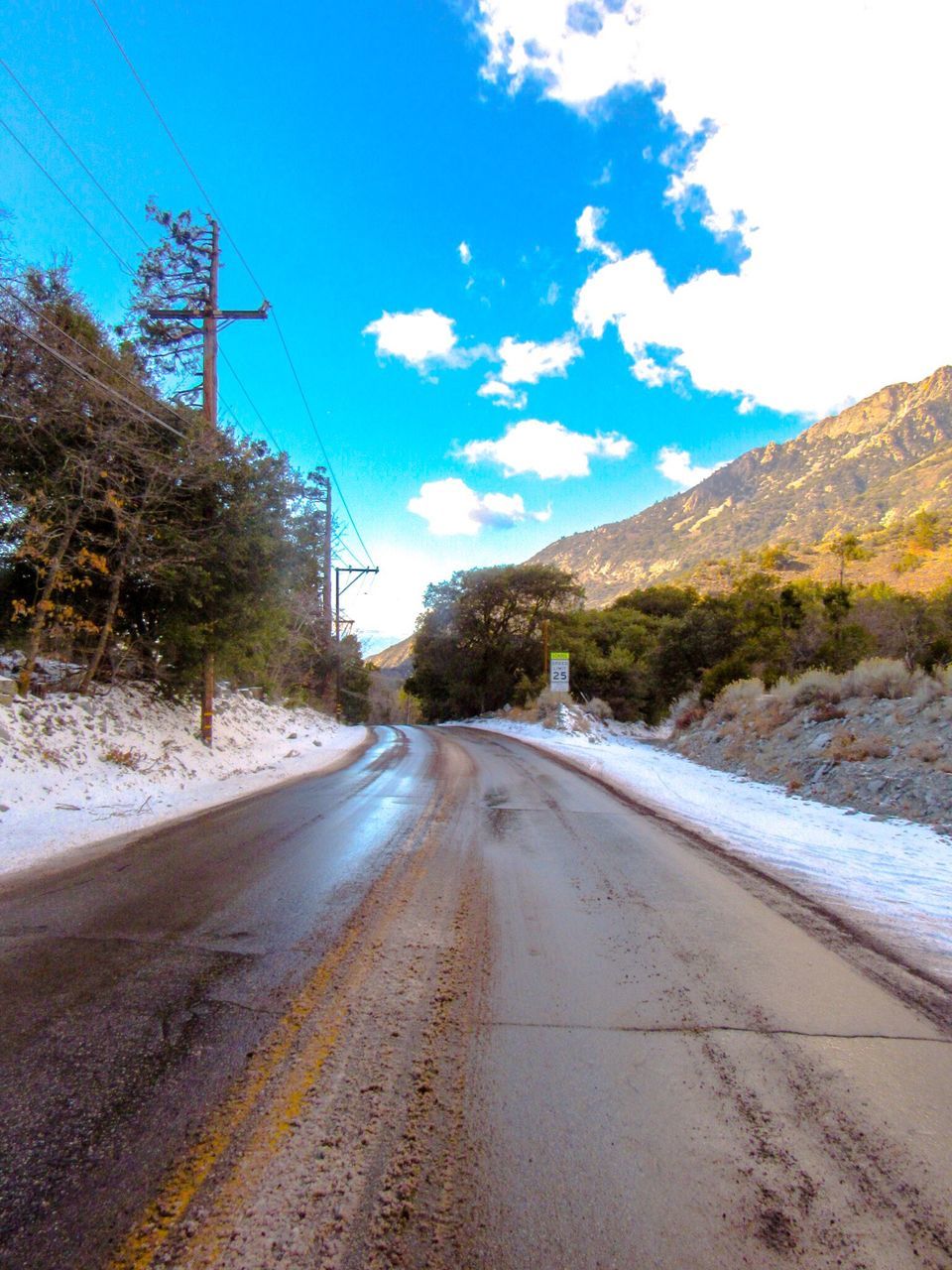 the way forward, road, transportation, sky, diminishing perspective, electricity pylon, vanishing point, power line, empty road, street, snow, country road, long, tree, blue, nature, asphalt, outdoors, day, mountain