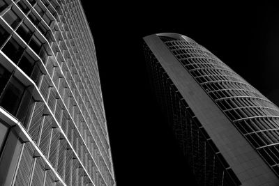 Low angle view of skyscrapers against sky at night