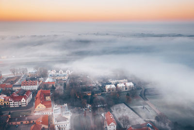 High angle view of buildings in city during sunset