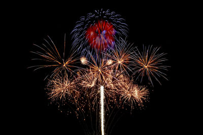 Low angle view of firework display at night