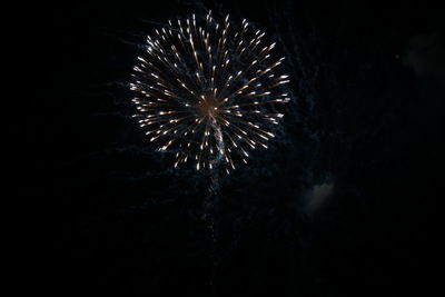 Low angle view of firework display at night