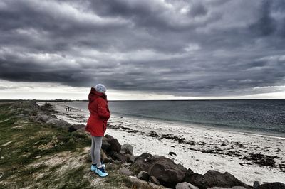 Man standing on beach against sky