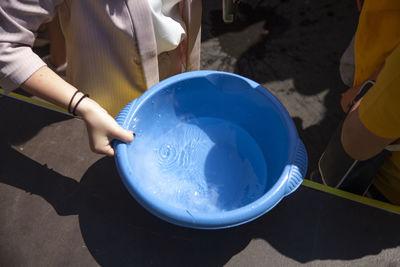 Midsection of man cleaning equipment